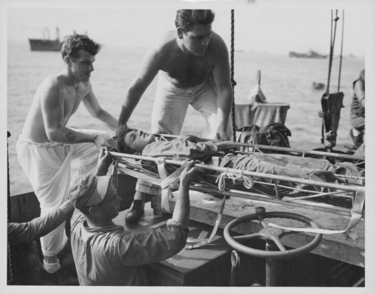 A wounded US Marine lifted aboard a Coast Guard-manned transport, during the Pacific Campaign of World War Two, Peleliu, Palau, 1944. (Photo by US Coast Guard/Getty Images)