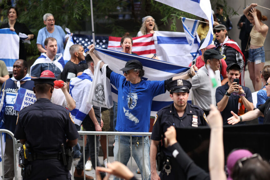 NEW YORK, NEW YORK - JUNE 05: NYPD officers stand in between Pro-Israel protestors and Pro-Palestine protestors during a rally against the Baruch College Hillel campus organization at Baruch College on June 05, 2024 in New York City. Several arrests by NYPD were made during and after a counter protest by Pro-Israel protestors against Pro-Palestine protestors who were demonstrating against the Baruch College Hillel campus organization's support of the Israel Defense Forces during the conflict with Hamas. The war has resulted in the deaths of over 35,000 Palestinians, mostly civilians, and has displaced 2.3 million people from their homes. The conflict was sparked by an attack from Hamas on October 7th. (Photo by Michael M. Santiago/Getty Images)