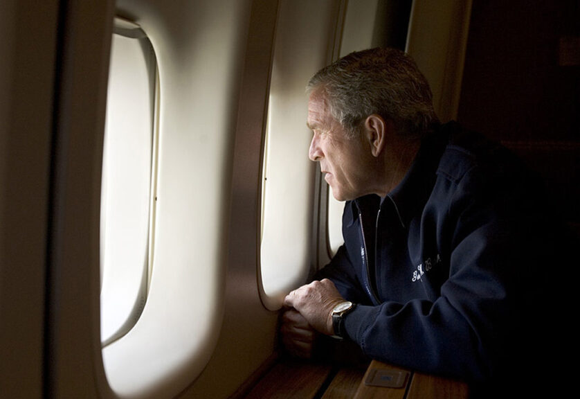 UNSPECIFIED - AUGUST 31: In this handout photo provided by the White House, U.S. President George W. Bush looks out over devastation from Hurricane Katrina as he heads back to Washington D.C. August 31, 2005 aboard Air Force One. Bush cut short his vacation and returned to Washington to monitor relief efforts for Hurricane Katrina. (Photo by Paul Morse/White House via Getty Images)