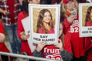 Supporters of former US President and 2024 presidential hopeful Donald Trump hold images of Laken Riley before he speaks at a "Get Out the Vote" rally in Rome, Georgia, on March 9, 2024. Riley, a nursing student, has become the face of immigration reform after her murder allegedly by an illegal immigrant on February 22, 2024. (Photo by Elijah Nouvelage / AFP) (Photo by ELIJAH NOUVELAGE/AFP via Getty Images)