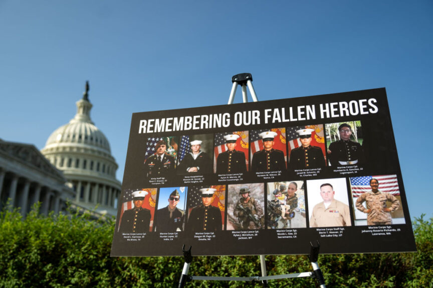 WASHINGTON, DC - SEPTEMBER 9: A sign displaying photos and names of the 13 service members killed in a terrorist attack at Abbey Gate outside Kabul's Hamid Karzai International Airport is seen during a news conference at the U.S. Capitol on September 9, 2024 in Washington, DC. Republicans and Democrats released competing reports on the 2021 United States' withdrawal from Afghanistan, with Republicans blaming President Biden for prioritizing optics over security, while Democrats accuse the GOP of manipulating facts. (Photo by Kent Nishimura/Getty Images)