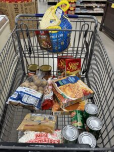 A shopping cart with items related to Thanksgiving dinner.