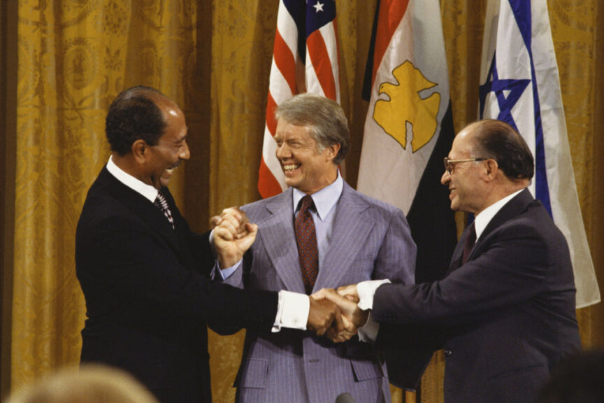 WASHINGTON - SEPTEMBER 18: (NO U.S. TABLOID SALES) (L-R) Egyptian President Anwar Sadat, U.S. President Jimmy Carter, and Israeli Prime Minister Menachem Begin join hands after the Camp David Accords September 18, 1978 in the East Room of the White House in Washington, DC. (Photo by David Hume Kennerly/Getty Images)