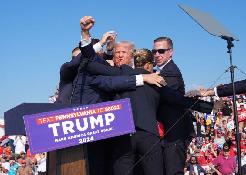 BUTLER, PENNSYLVANIA - July 13: Former president Donald Trump raises his arm with blood on his face during a campaign rally for former President Donald Trump at Butler Farm Show Inc. on Saturday, July 13, 2024 in Butler, Pa. Trump ducked and was taken offstage after loud noises were heard after he began speaking.