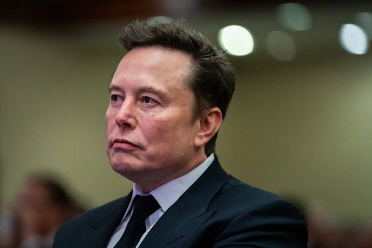 WASHINGTON, DC - NOVEMBER 13: Elon Musk listens as US President-elect Donald Trump speaks during a House Republicans Conference meeting at the Hyatt Regency on Capitol Hill on November 13, 2024 in Washington, DC. As is tradition with incoming presidents, President-elect Trump is traveling to Washington, DC to meet with U.S. President Joe Biden at the White House as well as Republican members of Congress on Capitol Hill.