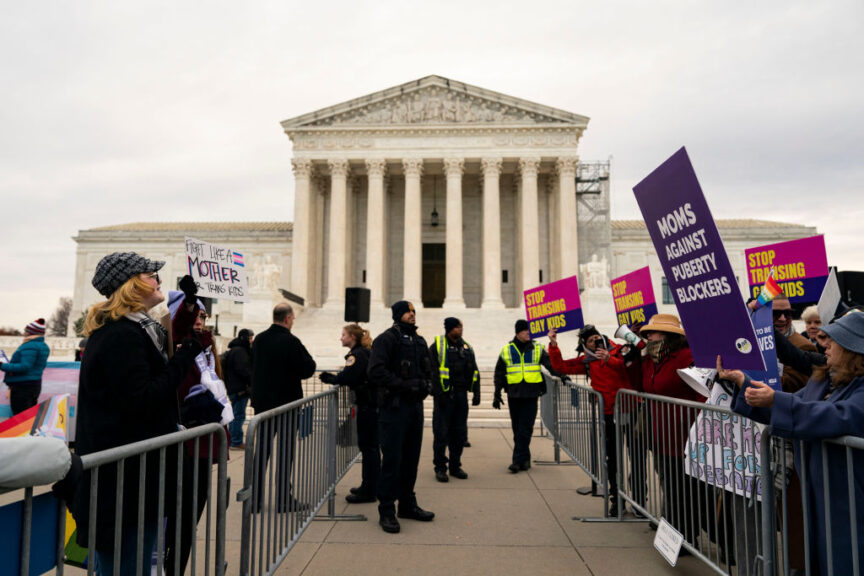 Police stand between demonstrators in support of gender affirming treatment, left, and demonstrators in support of the Tennessee case against gender affirming treatment for minors, right, outside the US Supreme Court in Washington, DC, US, on Wednesday, Dec. 4, 2024. The US Supreme Court is considering the constitutionality of state laws that ban gender-affirming treatments for minors less than five years after the justices outlawed job discrimination based on gender identity and sexual orientation.