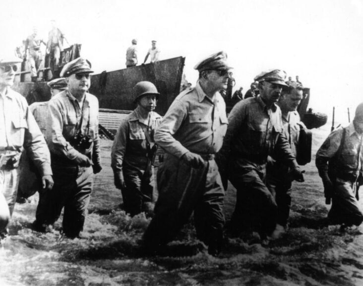 After being ordered to withdraw to Australia in 1942, General Douglas MacArthur returns to the Philippines, as he had promised the Philippine people. Here he is seen debarking from a barge on a Lingayen beach (Philippines), in 1945. (Photo by: Photo12/Universal Images Group via Getty Images)