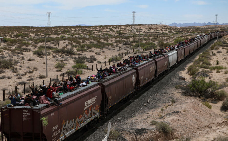 TOPSHOT - Migrant people of different nationalities seeking asylum in the United States travel on freight cars of the Mexican train known as "The Beast" as they arrive at the border city of Ciudad Juarez, in Chihuahua state, Mexico on April 24, 2024. (Photo by Herika Martinez / AFP) (Photo by HERIKA MARTINEZ/AFP via Getty Images)