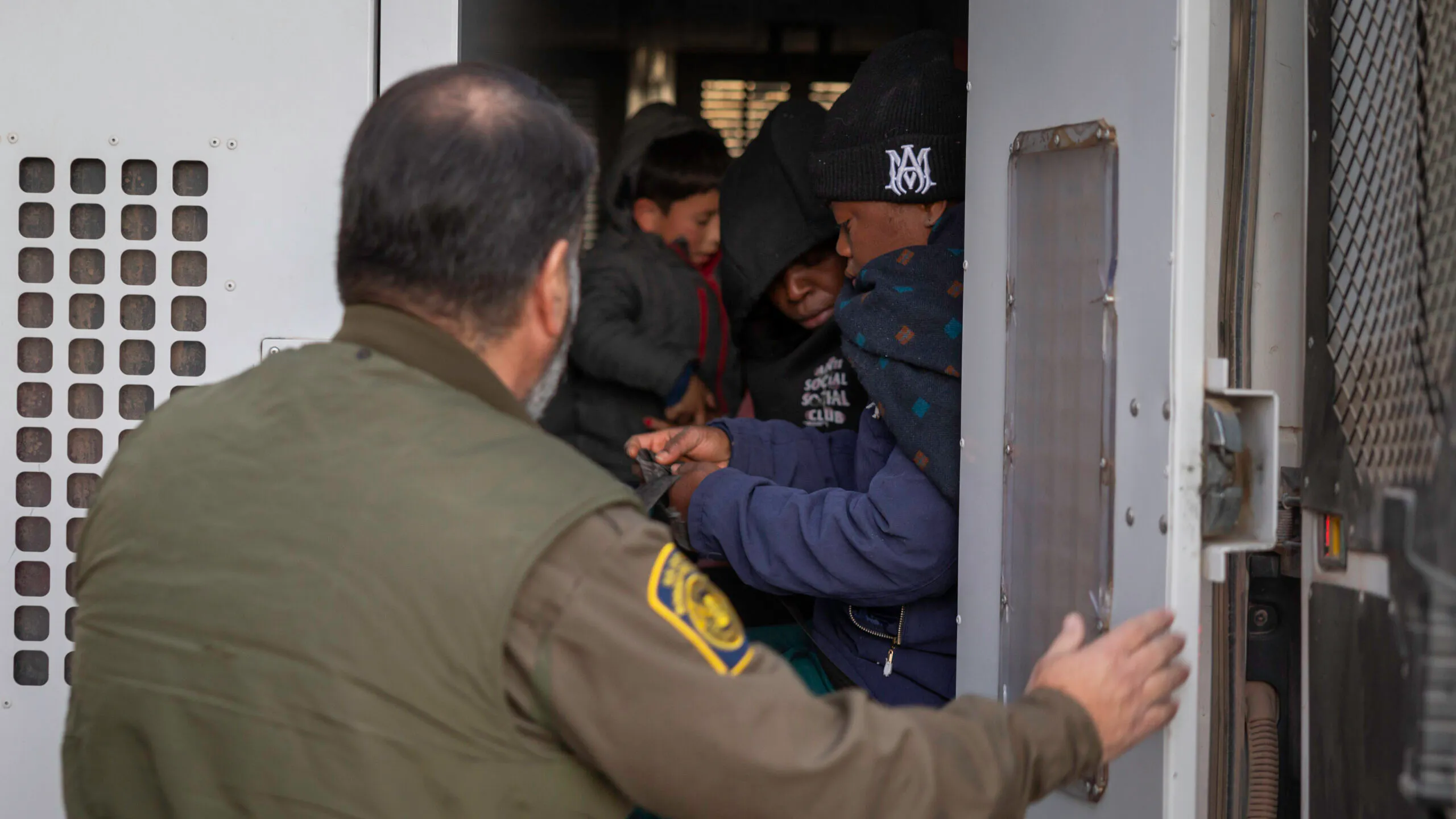 Immigrants prepare to be transported by the U.S. Border Patrol after crossing the U.S.-Mexico border on January 20, 2025 near Sasabe, Arizona.