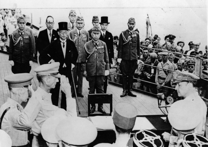 2nd September 1945: Sir Arthur Percival and Jonathan Wainwright salute General Douglas MacArthur (1880 - 1964) as Supreme Commander of the Allied Forces just before he accepts the Japanese unconditional surrender document. Mamoru Shigemitsu, the top-hatted foreign minister, along with General Yoshijiro Umezu, the army chief of staff, lead the Japanese delegaation, on board the USS Missouri in Tokyo Bay. (Photo by Keystone/Getty Images)