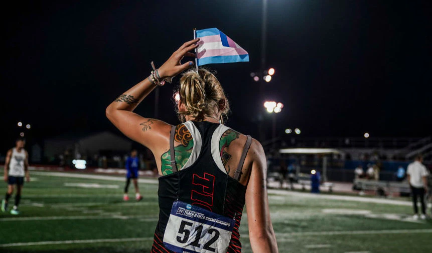 Sadie Schreiner puts a transgender flag in her hair before heading to the awards stand after finishing 3rd in the finals of the 200m race at the 2024 NCAA DIII outdoor track and field championships at Doug Shaw Memorial Stadium on May 25, 2024, in Myrtle Beach, SC.