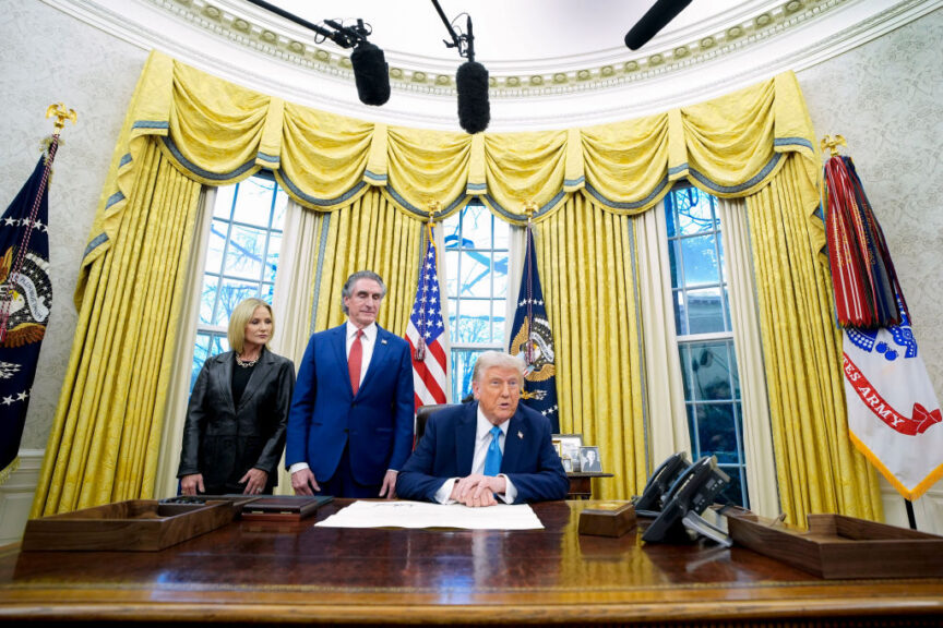 Kathryn Burgum, wife of Doug Burgum, from left, Doug Burgum, US secretary of the interior, and US President Donald Trump during an executive order signing ceremony in the Oval Office of the White House in Washington, DC, US, on Friday, Jan. 31, 2025. Trump said he would impose tariffs on a wide range of imports in the coming months, including steel, aluminum, oil and gas, pharmaceuticals, as well as semiconductors, while speaking during an executive order signing on deregulation. Photographer: Yuri Gripas/Abaca/Bloomberg via Getty Images