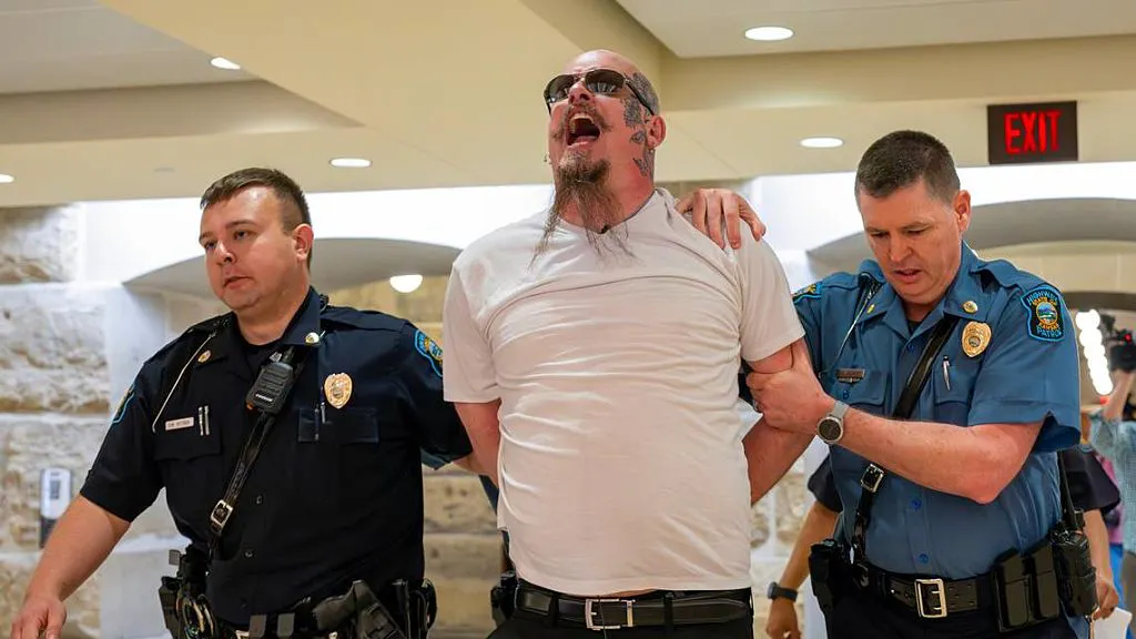 Satanist Arrested After Punching Protester At Black Mass In Kansas Statehouse