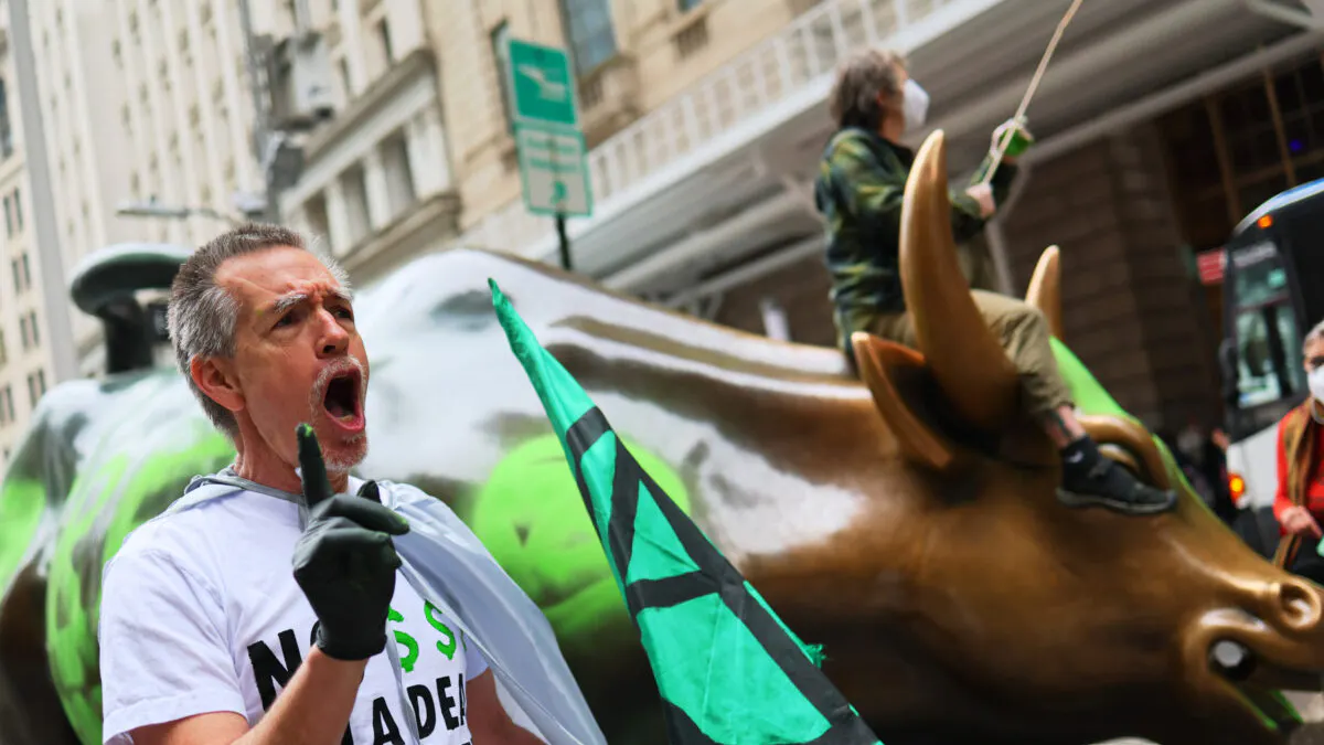Climate Activists Deface Wall Street Bull — Then Panic And Clean It Before Cops Come