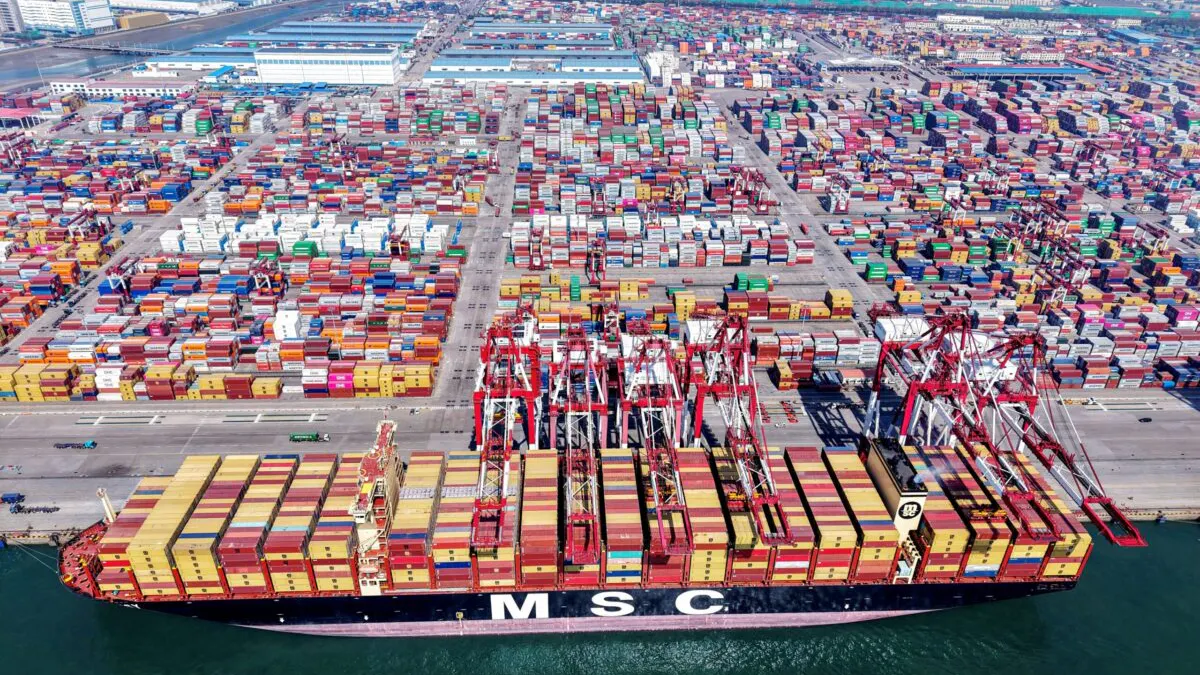 TOPSHOT - A container ship is seen at the port in Qingdao, in China's eastern Shandong province on April 15, 2025. China is expected to post first-quarter growth of around five percent on April 16, buoyed by exporters rushing to stave off higher US tariffs but still weighed by sluggish domestic consumption, analysts say.