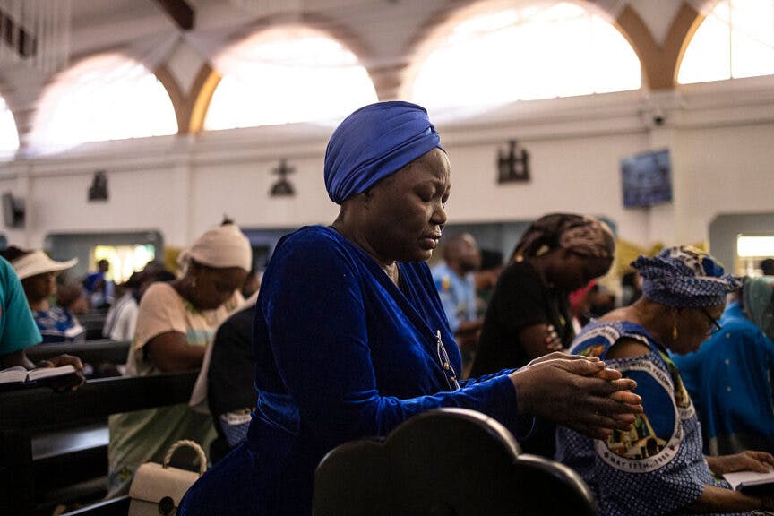 A worshipper prays as she attends a mass at Church of the Assumption in Lagos on April 21, 2025. African leaders praised the "legacy of compassion" and "commitment to inclusivity" of Pope Francis as they joined global mourning over his death on Monday. Francis, an energetic reformer who inspired widespread devotion from Catholics but riled traditionalists, died aged 88. The chairman of the African Union Commission, Mahmoud Ali Youssouf, praised "the Pope's courageous engagement with the African continent, amplifying the voices of the voiceless, championing peace and reconciliation, and standing in solidarity with those affected by conflict and poverty". (Photo by OLYMPIA DE MAISMONT / AFP) (Photo by OLYMPIA DE MAISMONT/AFP via Getty Images)