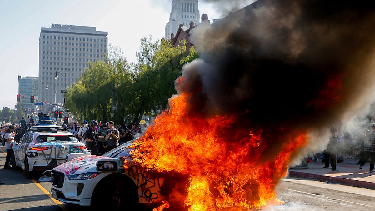 NextImg:Waymo Suspends Service In Downtown L.A. After Rioters Burn 5 Of Its Self-Driving Vehicles