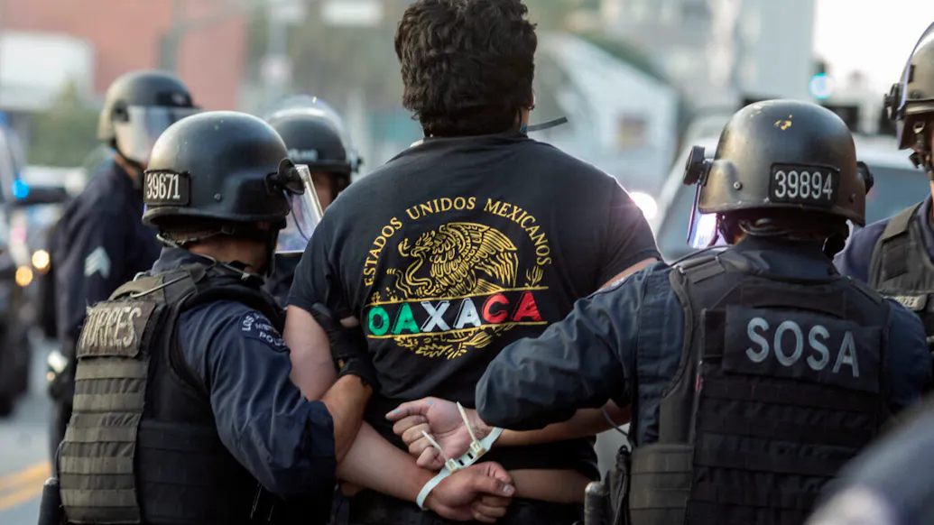 WATCH: L.A. Police Detain Reporter Live On-Air During Anti-ICE Riots