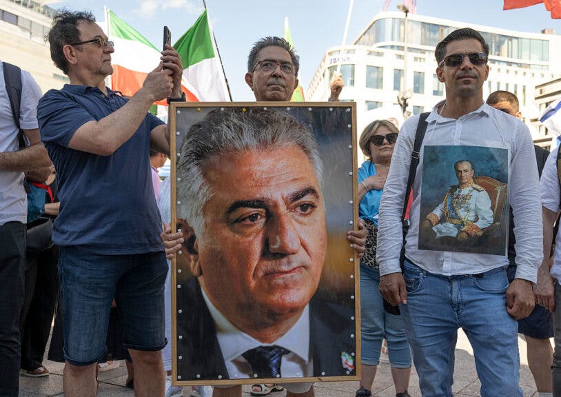28 June 2025, Hesse, Frankfurt/Main: Mainly exiles and German-Iranians protest against the Mullah regime in Iran at a rally at the Hauptwache in Frankfurt. One man holds a photo of Reza Pahlavi II, who is living in exile. Photo: Boris Roessler/dpa (Photo by Boris Roessler/picture alliance via Getty Images)