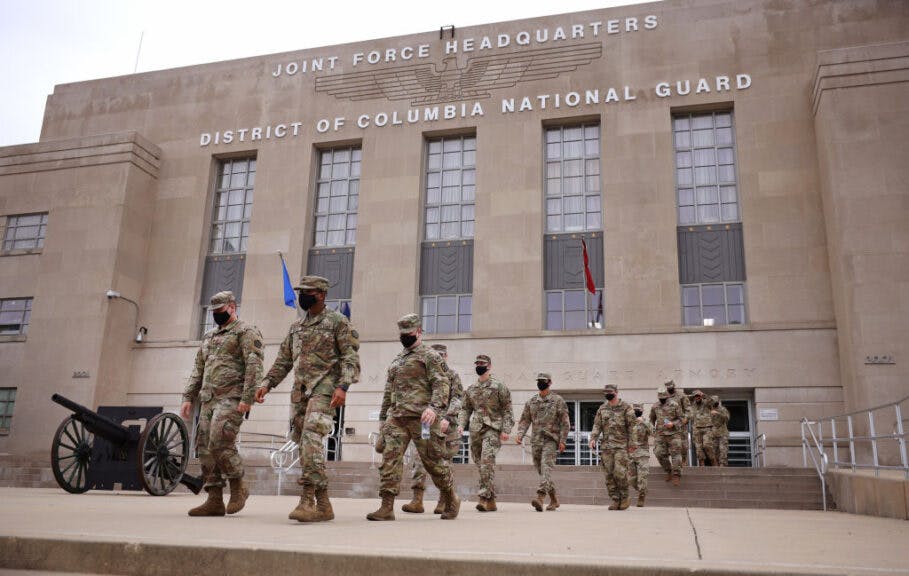 WASHINGTON, DC - MAY 24: National Guard troops make their way to buses as they leave the Armory after ending their mission of providing security to the U.S. Capitol on May 24, 2021 in Washington, DC. The troops are returning to their home states after a four-month deployment to the U.S. Capitol, where they assisted the U.S. Capitol Police with additional security following the January 6 insurrection. (Photo by Kevin Dietsch/Getty Images)