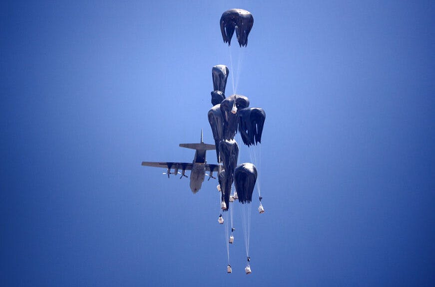 A C-130 Hercules military transport aircraft drops humanitarian aid on the northern Gaza Strip on July 27, 2025. Two Jordanian and one Emirati plane drop 25 tonnes of humanitarian aid over the Gaza Strip, Jordanian state television reports on July 27, 2025. (Photo by Majdi Fathi/NurPhoto via Getty Images)
