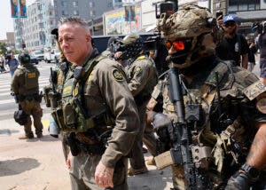 Los Angeles, CA - August 14: Gregory Bovino, Chief Patrol Agent of the El Centro Sector and Commander-Operation At Large CA (center), marches with federal agents to the Edward R. Roybal Federal Building after US Border Patrol agents produced a show of force outside the Japanese American National Museum where Gov. Newsom was holding a redistricting press conference on Thursday, Aug. 14, 2025 in Los Angeles, CA.