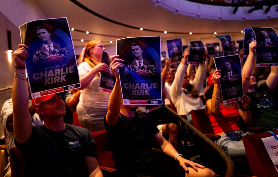 MINNEAPOLIS, MINNESOTA - SEPTEMBER 22: Attendees hold up posters of Charlie Kirk during the "American Comeback Tour" event at Northrop Auditorium on the University of Minnesota campus on September 22, 2025 in Minneapolis, Minnesota. The event was hosted by political commentator Michael Knowles after the assassination of Charlie Kirk earlier this month. (Photo by Stephen Maturen/Getty Images)