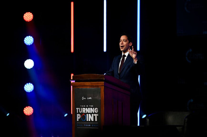 MINNEAPOLIS, MINNESOTA - SEPTEMBER 22: Political commentator Michael Knowles points to an empty chair on stage during the "American Comeback Tour" event at Northrop Auditorium on the University of Minnesota campus on September 22, 2025 in Minneapolis, Minnesota. The event was hosted by Knowles after the assassination of Charlie Kirk earlier this month. (Photo by Stephen Maturen/Getty Images)