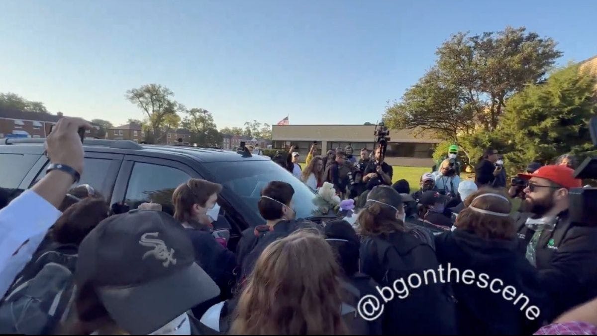 NextImg:Protesters Try To Block ICE Agents From Driving Into Illinois Facility
