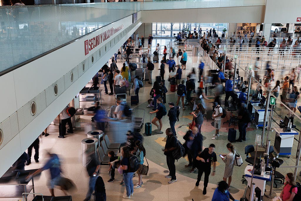 Travelers wait in line at the TSA security checkpoint at Dallas Love Field Airport (DAL) in Dallas, Texas, US, on Wednesday, Aug. 27, 2025. For the first time in almost 20 years, pre-flight screening as of last month no longer requires passengers to take off their shoes and run them through X-ray machines, and officials have signaled they intend to ease the rule limiting containers of carry-on liquids to no more than 3.4 ounces.