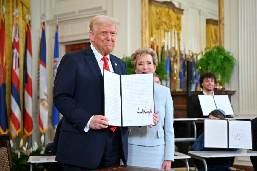 US President Donald Trump holds an executive order after signing it alongside US Secretary of Education Linda McMahon (R) in the East Room of the White house in Washington, DC, March 20, 2025. US President Donald Trump will sign an order March 20, 2025 to start dismantling the Department of Education, fulfilling an election campaign pledge and a long-held dream of American conservatives. By law, the Education Department -- created in 1979 -- cannot be shuttered without the approval of Congress, and Republicans do not have the votes to push that through. (Photo by Mandel NGAN / AFP)
