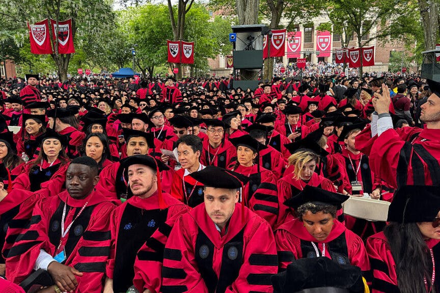 TOPSHOT - Graduates gather as they attend commencement ceremony at Harvard University in Cambridge, Massachusetts, on May 29, 2025. US President Donald Trump is furious at Harvard for rejecting his administration's push for oversight on admissions and hiring, amid the president's claims the school is a hotbed of anti-Semitism and