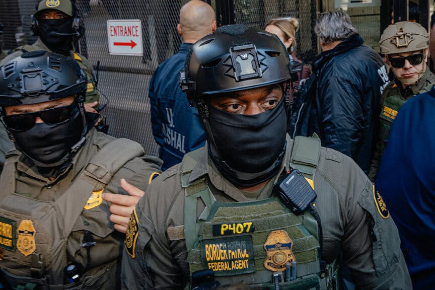 CHICAGO, ILLINOIS - OCTOBER 28: Masked federal agents walk alongside the Dirksen Federal Building on October 28, 2025, in Chicago, Illinois. The agents circled the courthouse ahead of U.S. Border Patrol commander Gregory Bovino's departure following a court appearance, where he faces accusations that he and other federal agents have defied court limits on tear gas and other crowd control tactics during President Donald Trump's Operation Midway Blitz enforcement surge across the Chicago area. (Photo by Jamie Kelter Davis/Getty Images)