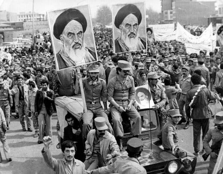 The Iranian Islamic Republic Army demonstrates in solidarity with people in the street during the Iranian revolution. They are carrying posters of the Ayatollah Khomeini, the Iranian religious and political leader. (Photo by Keystone/Getty Images)