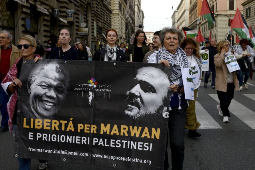 ROME, ITALY - MARCH 30: Protesters carry a banner calling for freedom for Marwan Barghouti as they attend a demonstration, in solidarity with the Palestinian people, against Israel’s Gaza bombardment and to call for a ceasefire on March 30, 2024 in Rome, Italy. The demonstration dedicated to "Earth Day" is organized by the Palestinian Students Movement, the Palestinian Arab Democratic Union (UDAP), the Association of Palestinians in Italy and the Coordination of Solidarity with the Palestinian People. (Photo by Simona Granati - Corbis/Corbis via Getty Images)