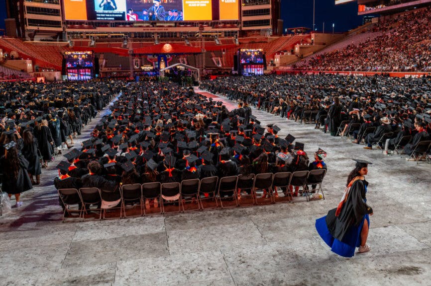 AUSTIN, TEXAS - MAY 11: A student walks through commencement at the DKR-Texas Memorial Stadium on May 11, 2024 in Austin, Texas. Amid nationwide tension on college campuses over the war between Israel and Hamas, students continue protesting and calling for universities to divest from Israel. (Photo by Brandon Bell/Getty Images)