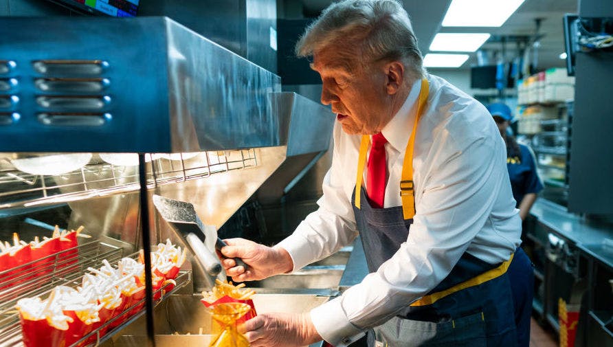 Republican presidential nominee, former U.S. President Donald Trump works behind the counter during a campaign event at McDonald's restaurant on October 20, 2024 in Feasterville-Trevose, Pennsylvania.