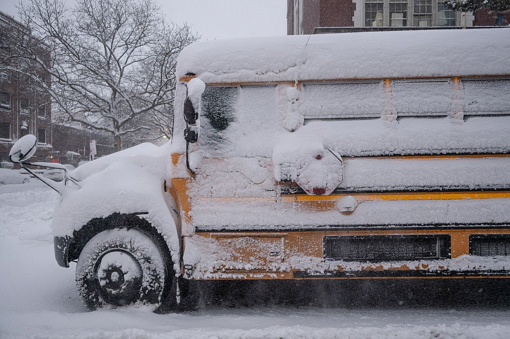 A school bus covered in snow during a winter storm in the Brooklyn borough of New York, US, on Monday, Feb. 23, 2026. A powerful winter storm has cut off New York City, grounding thousands of flights and straining transport networks, as 41 million people along the US East Coast brace for blizzard conditions in what could be one of the city's worst storms on record.