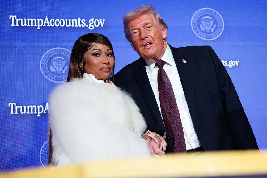 WASHINGTON, DC - JANUARY 28: Musician Nicki Minaj (L) joins U.S. President Donald Trump on stage as he delivers remarks during the Treasury Department's Trump Accounts Summit at Andrew W. Mellon Auditorium on January 28, 2026 in Washington, DC. 