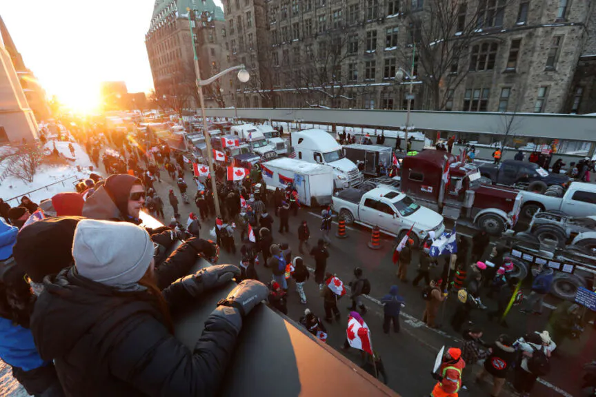 Demonstrators gather as rows of trucks sit parked on Wellington Street during a protest near Parliament Hill in Ottawa, Ontario, Canada, on Saturday, Jan. 29, 2022. A convoy of truckers and others who oppose vaccine mandates began rolling into Ottawa on Friday, putting Canada's capital city on edge amid warnings from police that they dont know how large the protests will get. Photographer: David Kawai/Bloomberg via Getty Images