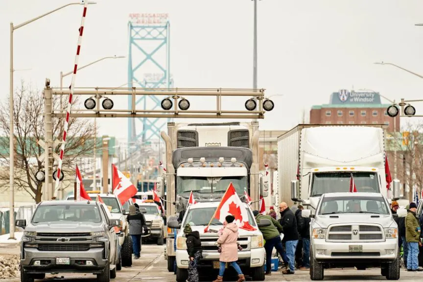 TOPSHOT - Supporters of the Truckers Convoy against the Covid-19 vaccine mandate block traffic in the Canada bound lanes of the Ambassador Bridge border crossing, in Windsor, Ontario on February 8, 2022. - The protestors have blocked traffic in the Canada bound lanes since Monday evening. Approximately $323 million worth of goods cross the Windsor-Detroit border each day at the Ambassador Bridge making it North Americas busiest international border crossing. (Photo by Geoff Robins / AFP) (Photo by GEOFF ROBINS/AFP via Getty Images)