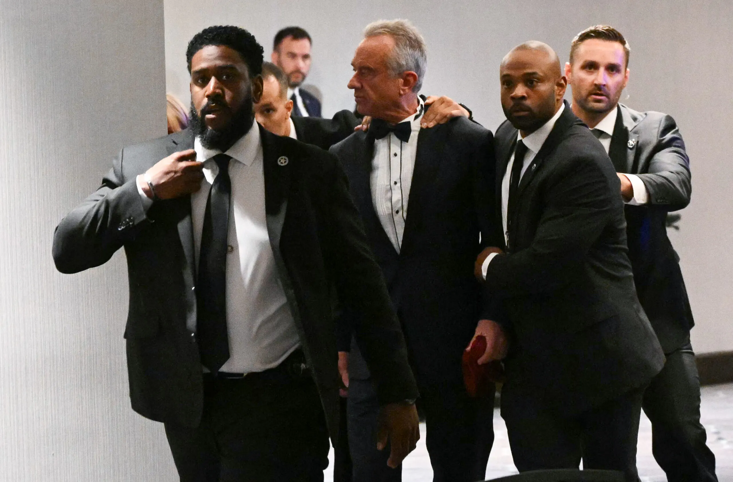 US Secretary of Health and Human Services Robert F. Kennedy Jr. is rushed out by Secret Service agents after loud bangs were heard during the White House Correspondents' dinner at the Washington Hilton in Washington, DC, on April 25, 2026.
