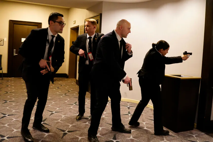 Federal agents draw their guns out after an incident at the annual White House Correspondents Association Dinner April 25, 2026 in Washington, DC.