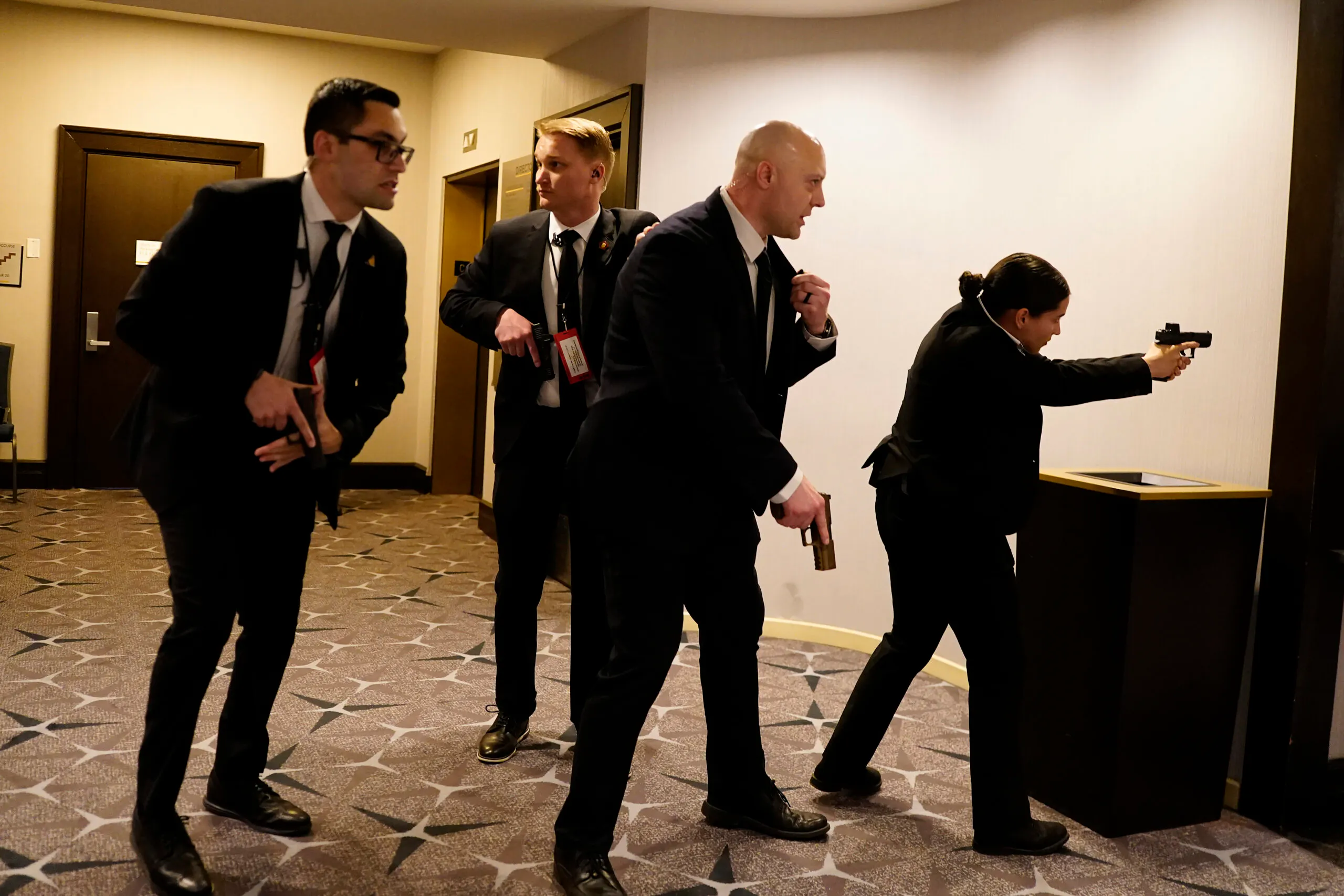 Federal agents draw their guns out after an incident at the annual White House Correspondents Association Dinner April 25, 2026 in Washington, DC.