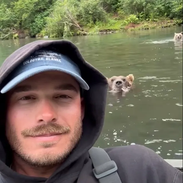WATCH: Massive Brown Bear Comes Within Feet Of Fisherman To Grab Salmon