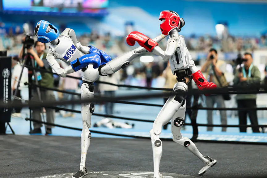 BEIJING, CHINA - AUGUST 26: Humanoid robots fight during a kickboxing match during the 2nd World Humanoid Robot Games at National Speed Skating Oval on August 26, 2026 in Beijing, China. (Photo by Lintao Zhang/Getty Images)
