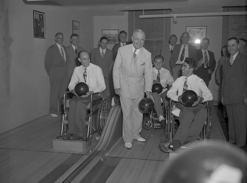 The champs are the three top winners of the national 10-pin bowling tournament that VA conducted in six of its paraplegic centers where paralyzed vets receive special treatment. Left to right: Gordon C. Scott of Crossville, Ala., patient at Memphis, Tenn., VA hospital; Leo Ladduceur of Detroit, Mich., and Gerald A. Kopp of Spokane, Wash., both patients at the Van Nuys, Calif., hospital, and President Truman.
