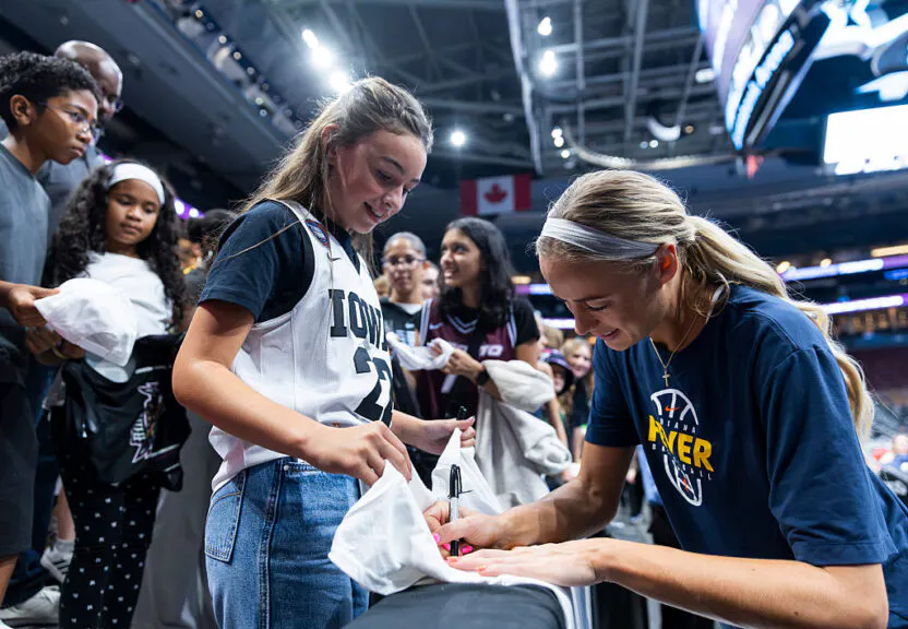 Sophie Cunningham #8 of the Indiana Fever signs autographs ahead of an WNBA game against the Toronto Tempo at Scotiabank Arena on August 18, 2026 in Toronto, Canada.