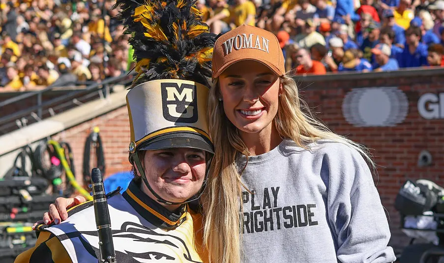 WNBA star and Missouri Tigers alumni Sophie Cunningham poses for a picture with a marching band member before an SEC football game between the Florida Gators and Missouri Tigers on Oct 3, 2026 at Memorial Stadium in Columbia, MO. 